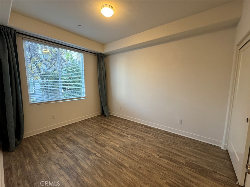 9042 Garvey Avenue, Unit 16 Rosemead, CA 91770 - Photo 19 of 28 a view of an empty room with wooden floor and a window