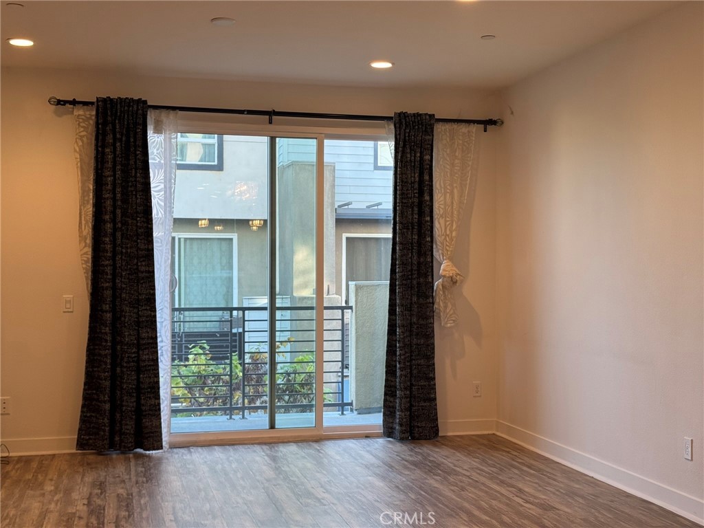 9042 Garvey Avenue, Unit 16 Rosemead, CA 91770 - Photo 21 of 28 an empty room with wooden floor and windows