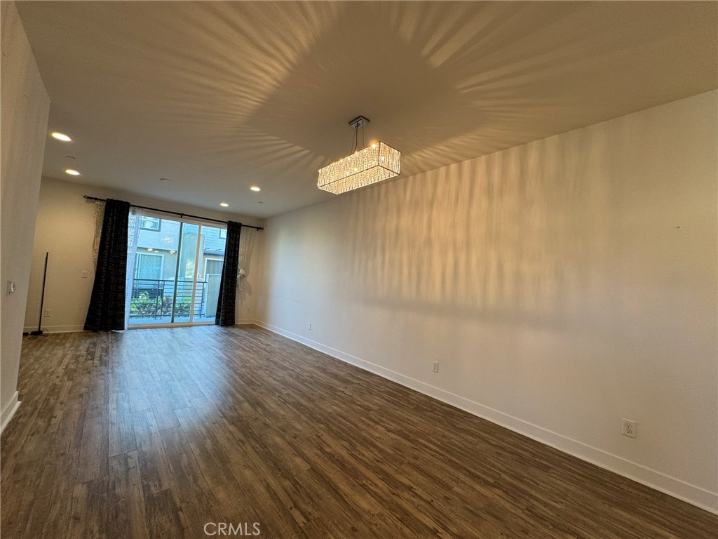 9042 Garvey Avenue, Unit 16 Rosemead, CA 91770 - Photo 22 of 28 a view of an empty room with wooden floor and windows
