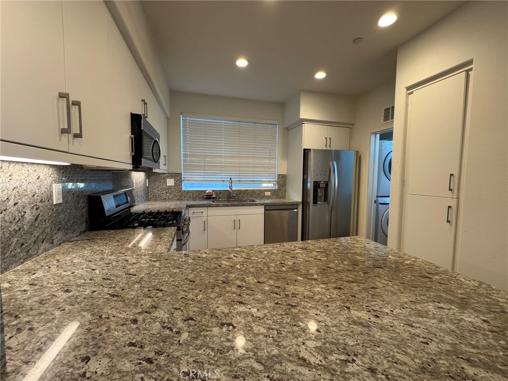 9042 Garvey Avenue, Unit 16 Rosemead, CA 91770 - Photo 27 of 28 a kitchen with granite countertop a refrigerator and a sink