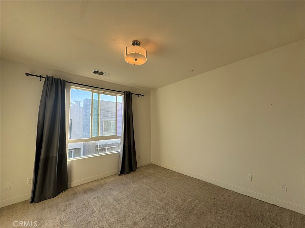9042 Garvey Avenue, Unit 16 Rosemead, CA 91770 - Photo 10 of 28 an empty room with windows