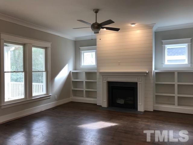 902 Norris Street Raleigh, NC 27604 - Photo 13 of 25 Family Room with Plenty of Natural Light. Extended Family Room with Two Foot Bump, Shiplap above gas fireplace, bookshelves, craftsmen trim and crown molding, conduit above fireplace, site finished hardwoods...