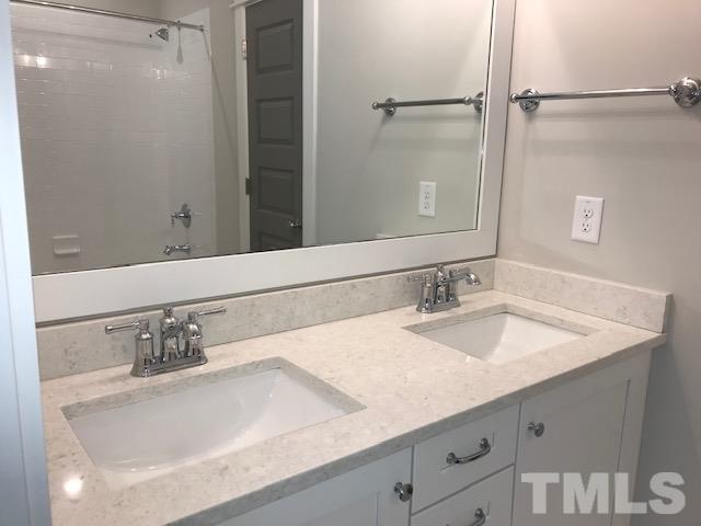 902 Norris Street Raleigh, NC 27604 - Photo 19 of 25 Double sinks, linen closet, shower/tub with tile surround.