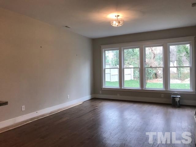 902 Norris Street Raleigh, NC 27604 - Photo 21 of 25 Tall ceilings, open space, hardwoods throughout the basement, bar with sink and wine fridge.