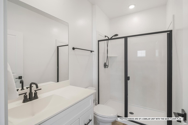 1702 Ripple Rock Drive, Unit 3171 Washington, UT 84780 - Photo 5 of 16 Bathroom featuring a white vanity with integrated sink, matte black faucet, and a frameless mirror