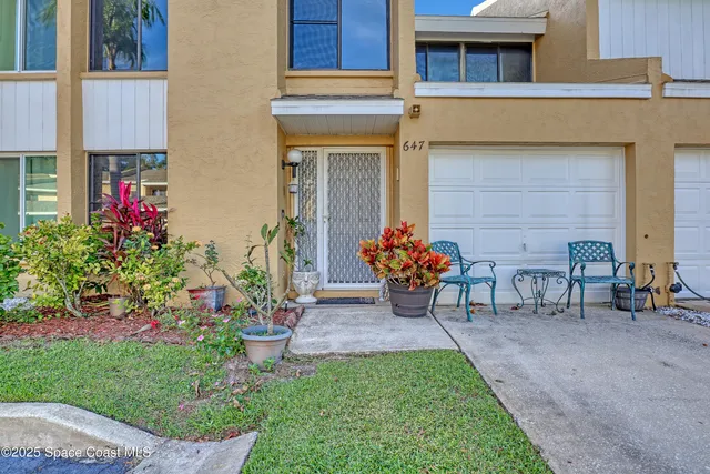a view of a house with a yard and sitting area