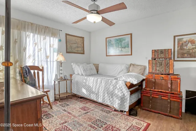 a bedroom with furniture and a window