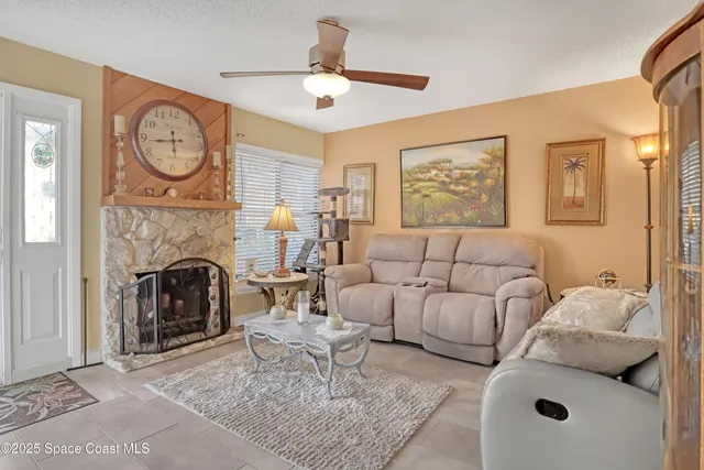 a living room with furniture a clock and a fireplace
