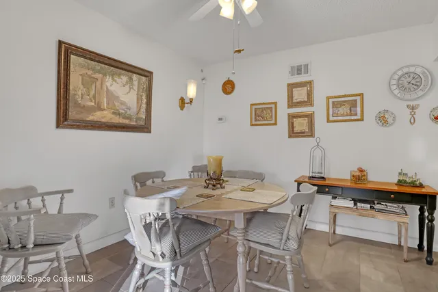 a view of a dining room with furniture and a potted plant