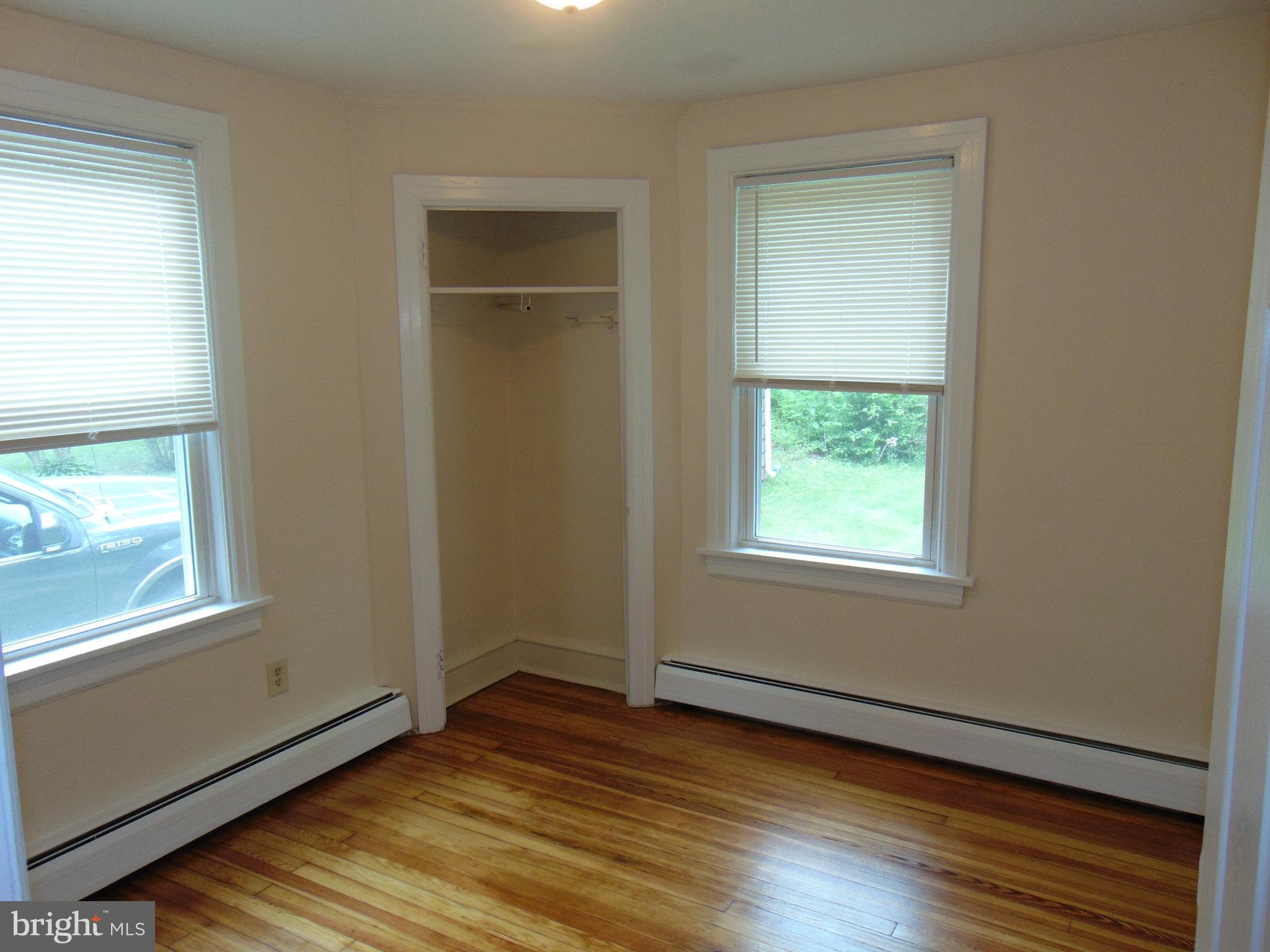 1311 Bristol Road, Unit 1 Churchville, PA 18966 - Photo 8 of 13 an empty room with wooden floor closet and windows