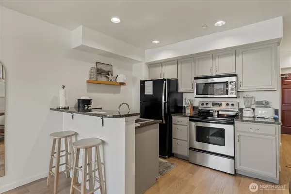 a kitchen with stainless steel appliances a refrigerator stove and microwave