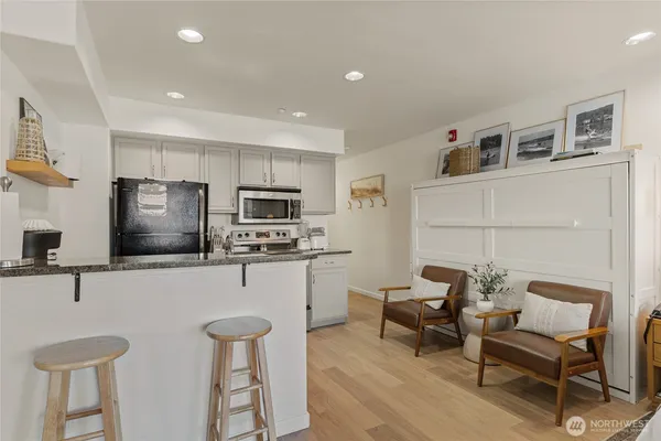 a kitchen with stainless steel appliances kitchen island granite countertop a sink and cabinets