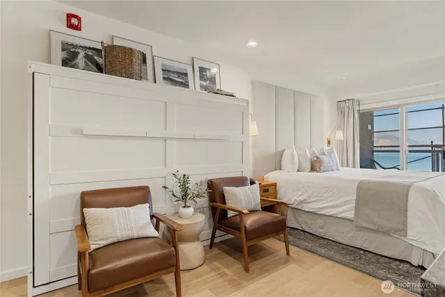 a bedroom with a bed wooden floor and window
