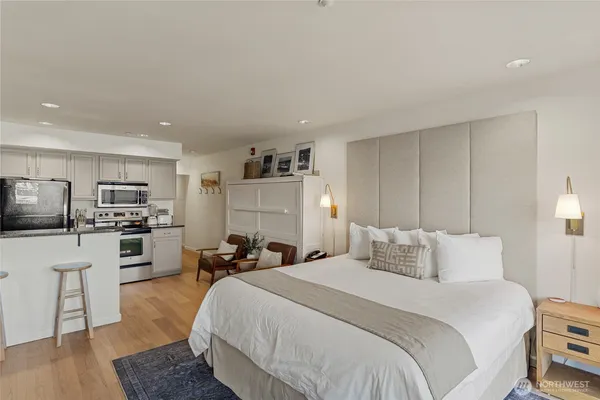 a bedroom with a bed a table and chair