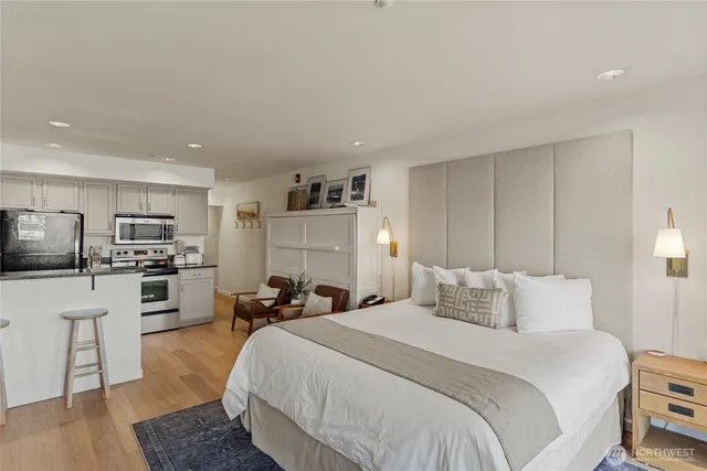 a bedroom with a bed a table and chair