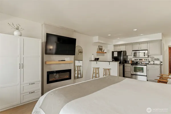 a bedroom with a bed and a television