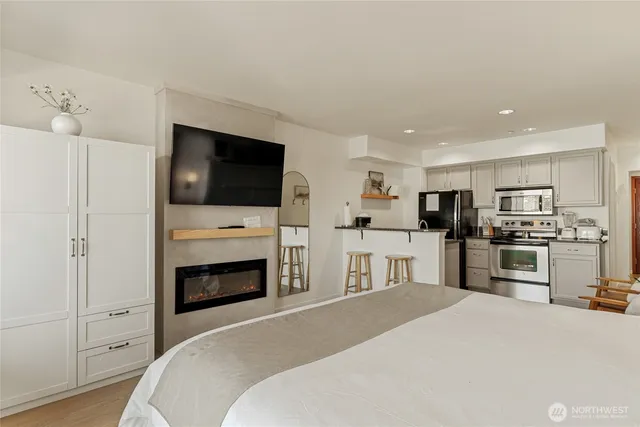 a bedroom with a bed and a television