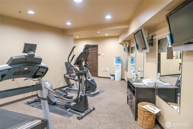 a room with gym equipment and windows