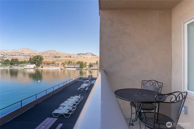 a view of a lake with a table and chairs