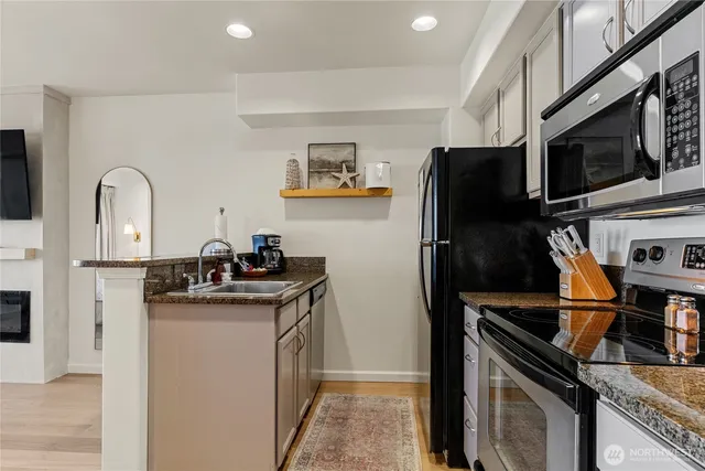 a kitchen with stainless steel appliances a sink stove and refrigerator