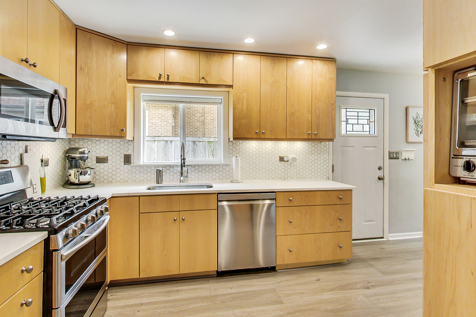 3609 North Harding Avenue Chicago, IL 60618 - Photo 11 of 41 a kitchen with stainless steel appliances granite countertop a stove a sink and a refrigerator