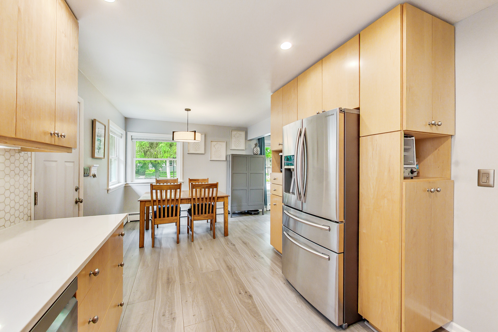 3609 North Harding Avenue Chicago, IL 60618 - Photo 12 of 41 a kitchen with stainless steel appliances granite countertop a refrigerator dining table and chairs
