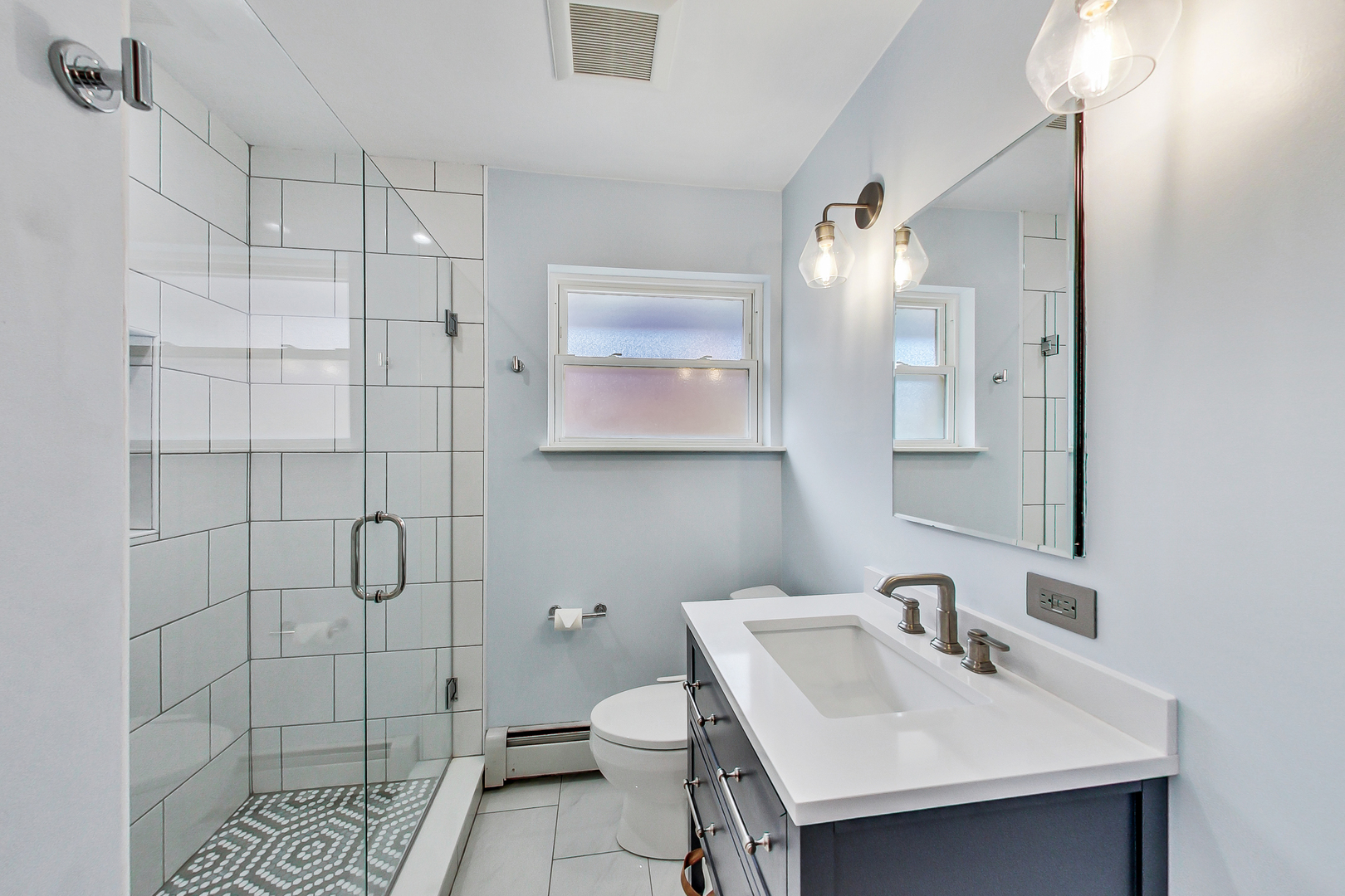 3609 North Harding Avenue Chicago, IL 60618 - Photo 22 of 41 a bathroom with a sink toilet and shower