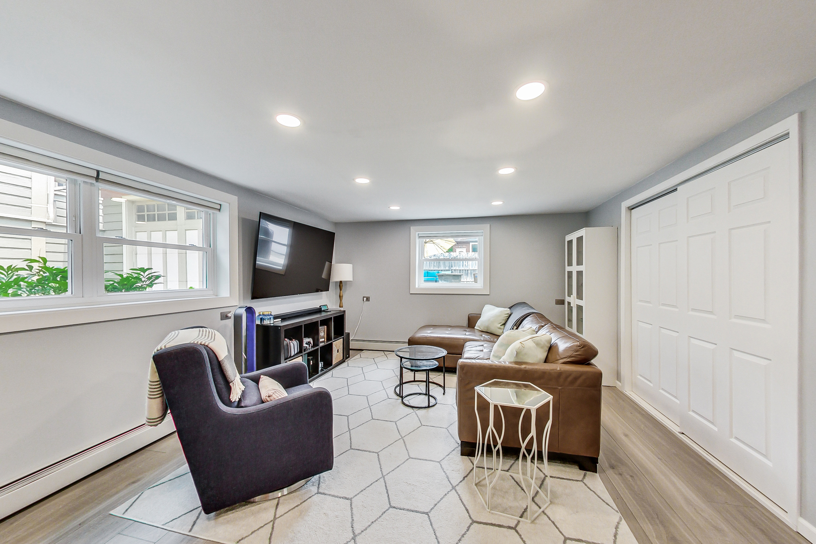 3609 North Harding Avenue Chicago, IL 60618 - Photo 25 of 41 a living room with furniture a flat screen tv and a fireplace