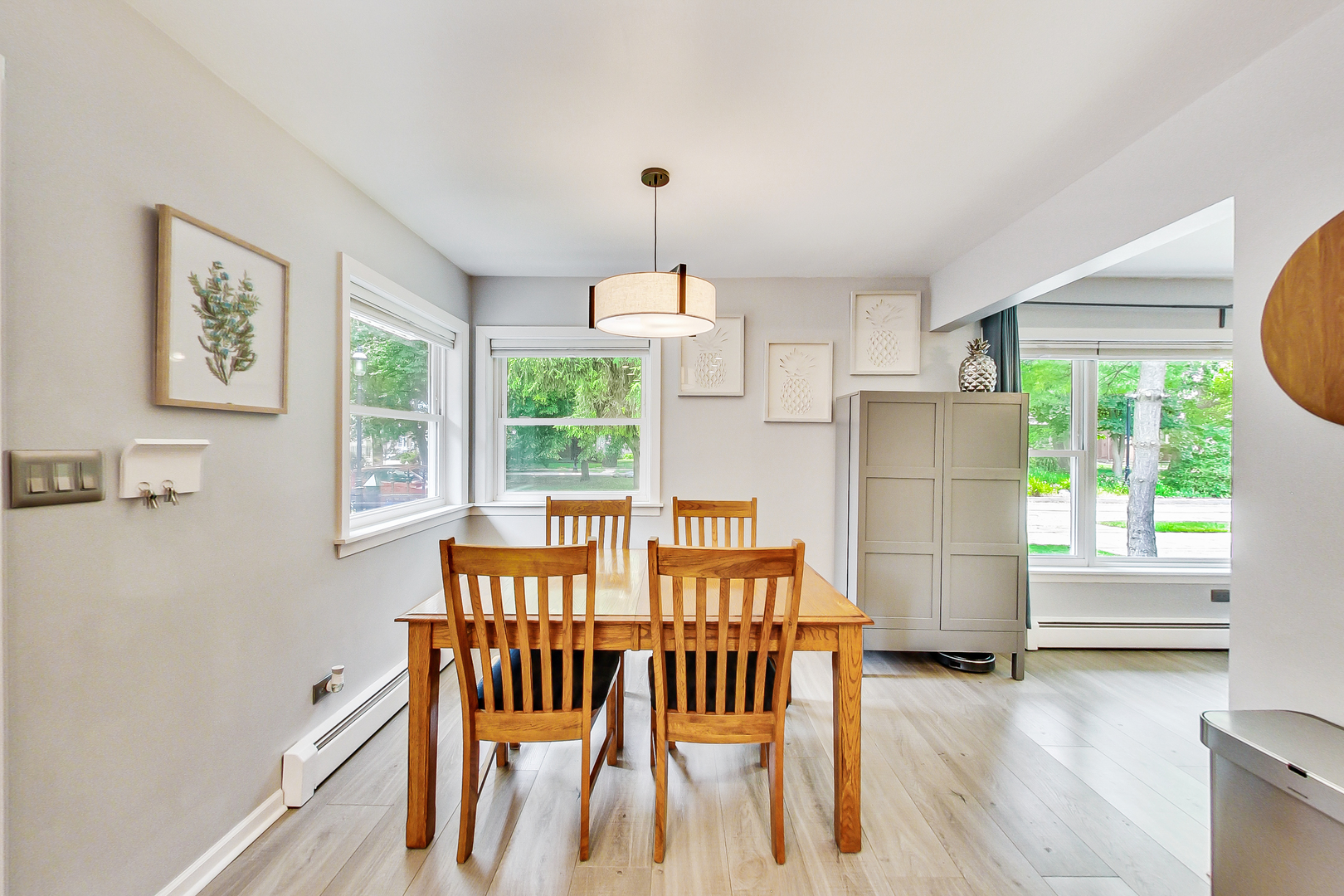 3609 North Harding Avenue Chicago, IL 60618 - Photo 8 of 41 a dining room with furniture a chandelier and wooden floor