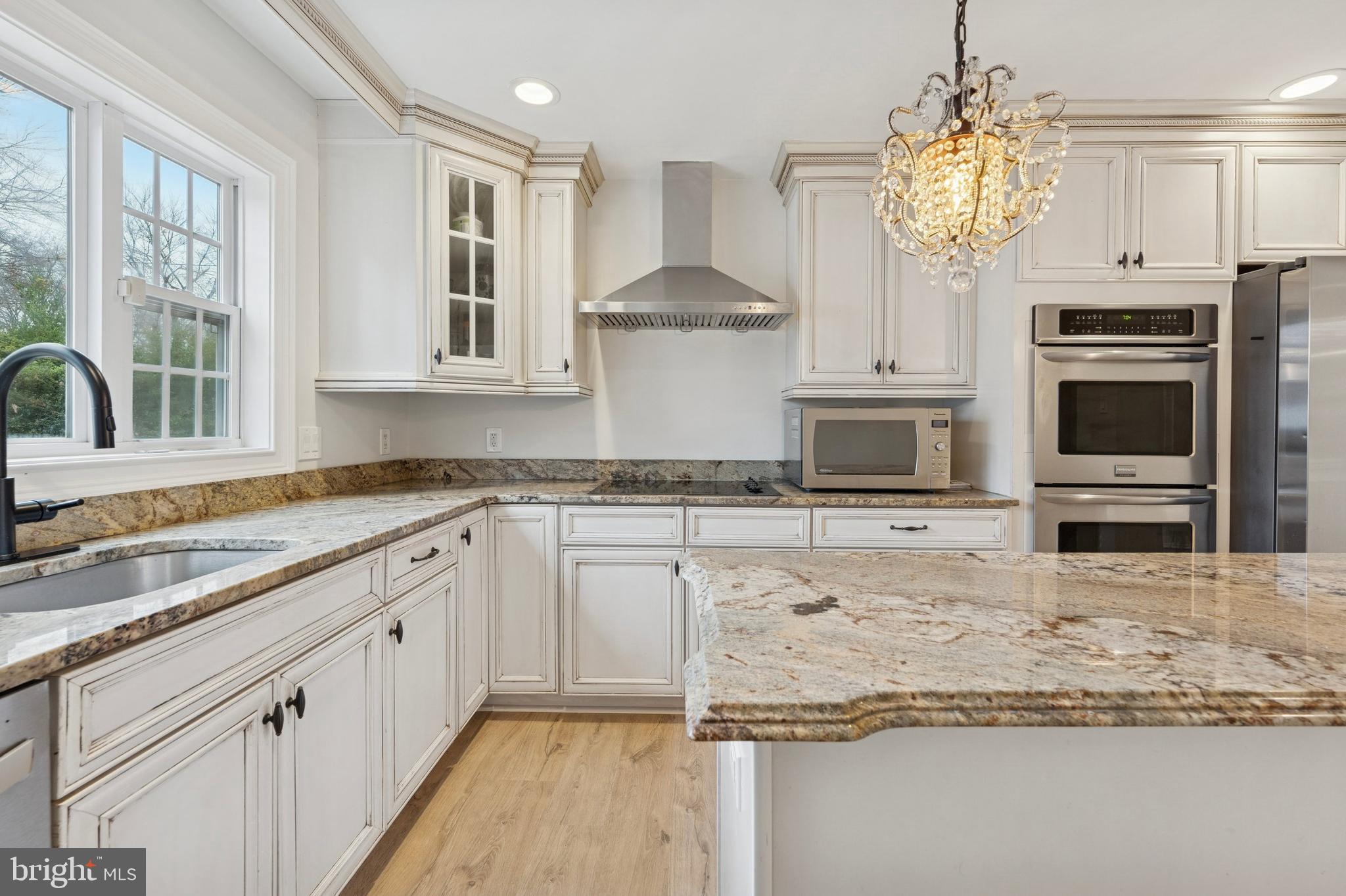 440 Rittenhouse Boulevard Jeffersonville, PA 19403 - Photo 16 of 45 a kitchen with stainless steel appliances granite countertop a stove a sink and a microwave