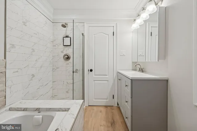 a bathroom with a tub sink and shower