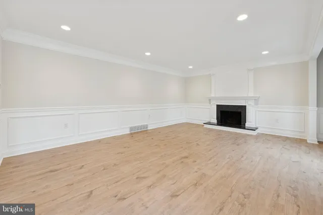 a view of a dining room with furniture a chandelier and wooden floor
