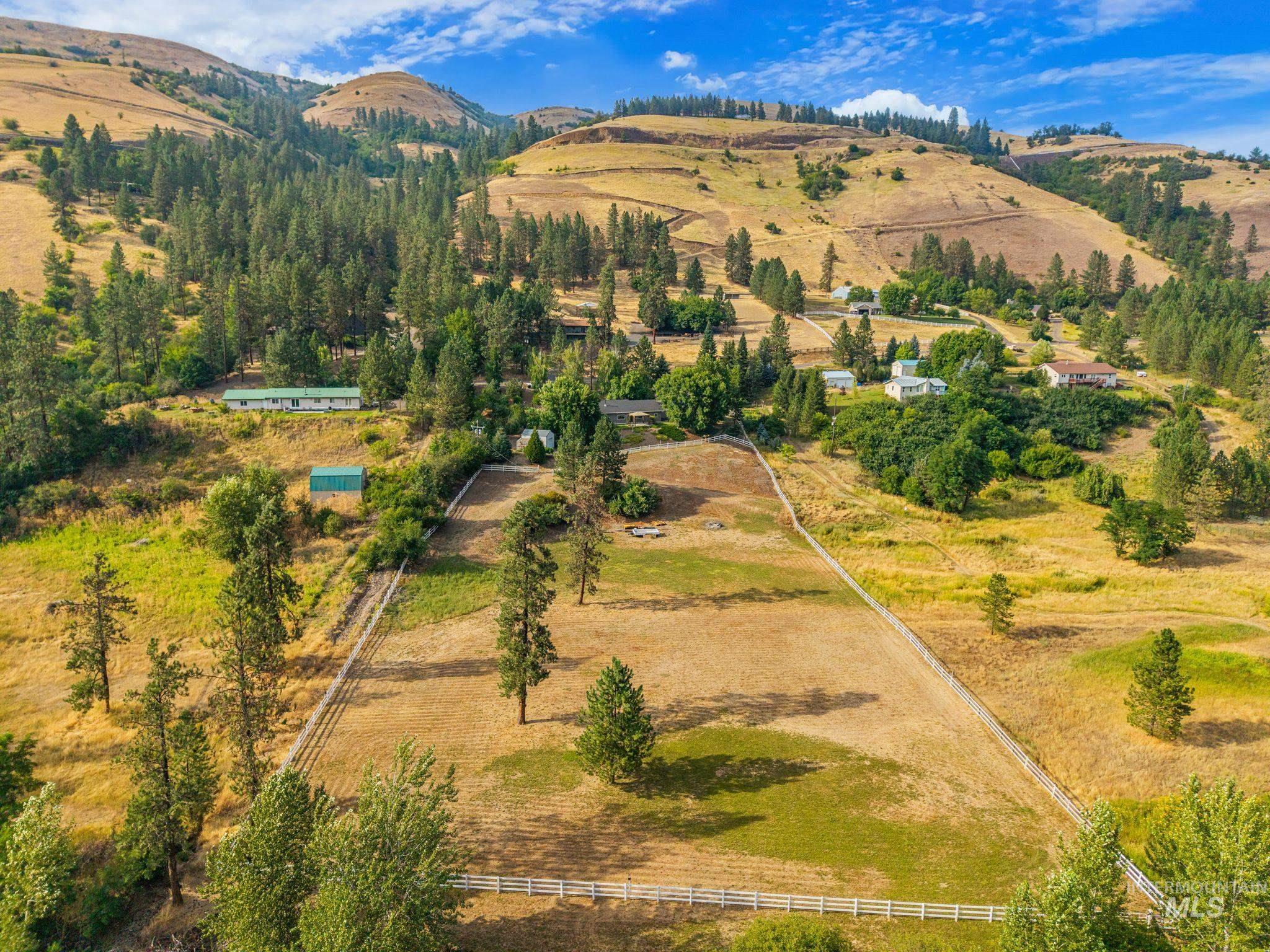 1091 Cedar Ridge Road Kendrick, ID 83537 - Photo 43 of 48 Expansive property featuring rolling hills, mature trees, and a white perimeter fence