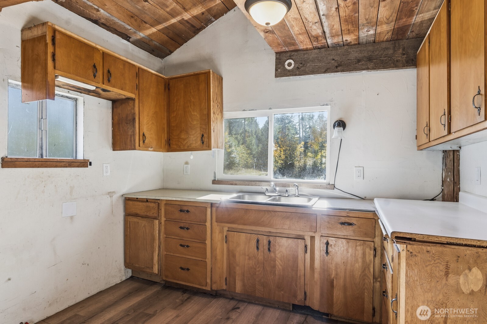17328 Mulqueen Road Southeast Rainier, WA 98576 - Photo 14 of 24 a bathroom with a granite countertop sink a mirror and a window