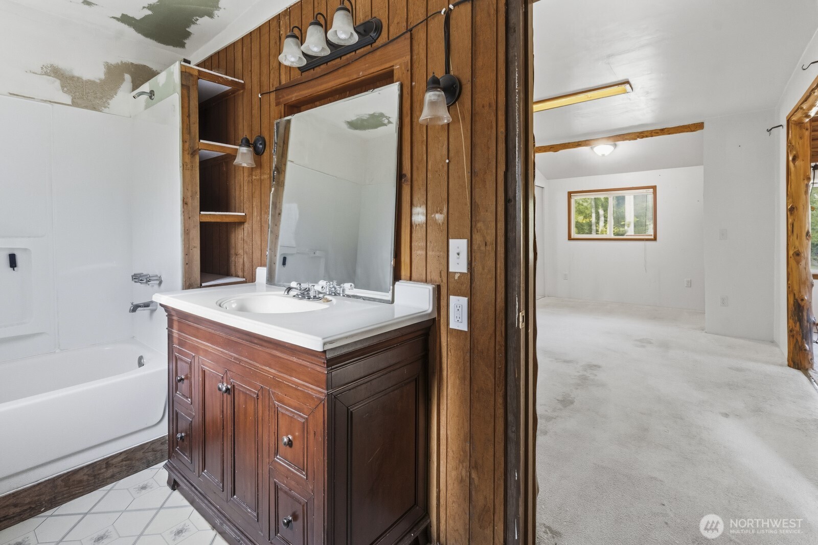 17328 Mulqueen Road Southeast Rainier, WA 98576 - Photo 18 of 24 a bathroom with a sink a mirror and a bathtub