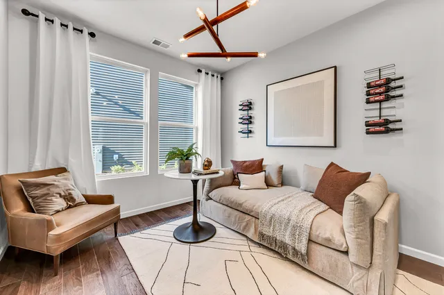 a bedroom with furniture and a large window