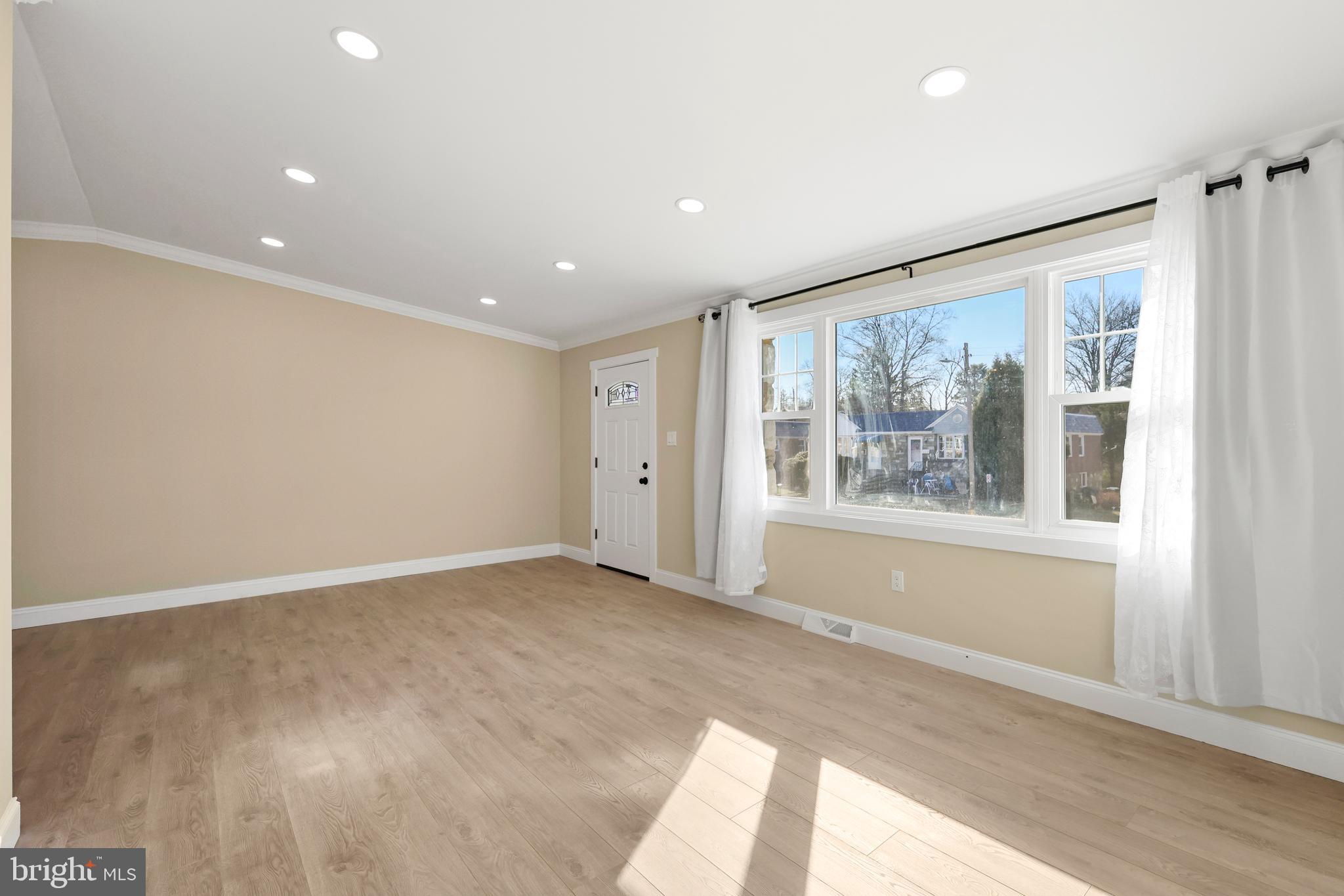 602 Wanamaker Road Jenkintown, PA 19046 - Photo 4 of 39 an empty room with wooden floor and windows