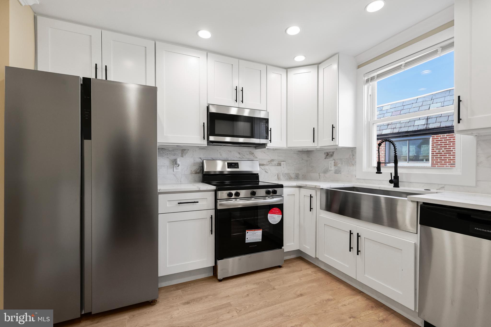 602 Wanamaker Road Jenkintown, PA 19046 - Photo 9 of 39 a kitchen with stainless steel appliances granite countertop a refrigerator stove a sink and dishwasher with wooden floor