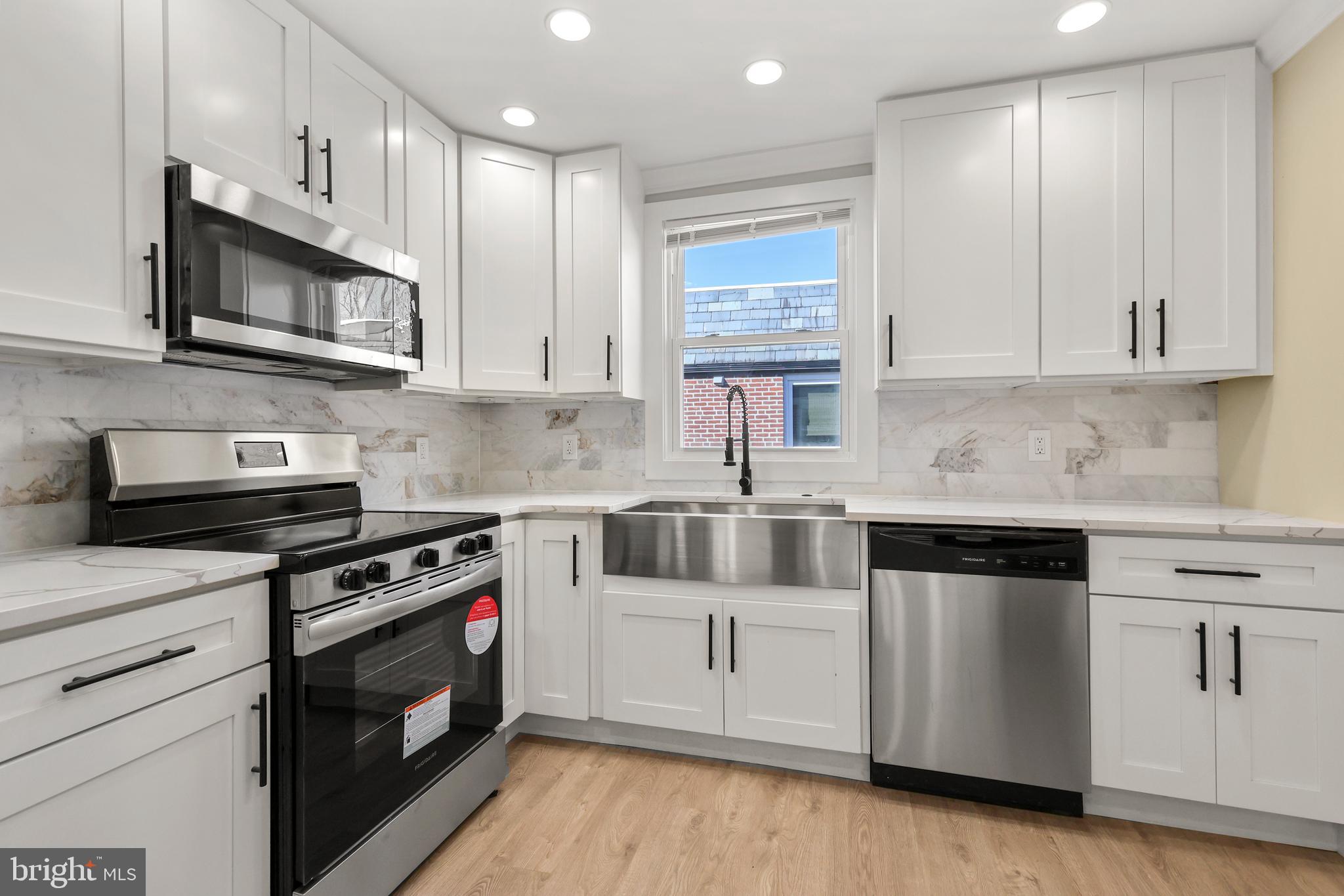 602 Wanamaker Road Jenkintown, PA 19046 - Photo 10 of 39 a kitchen with stainless steel appliances granite countertop a stove a sink and a microwave