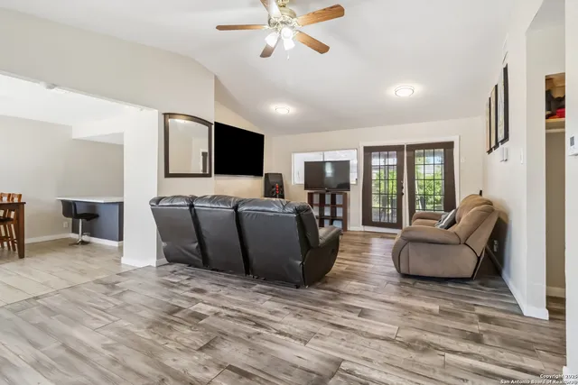 a living room with furniture and a flat screen tv