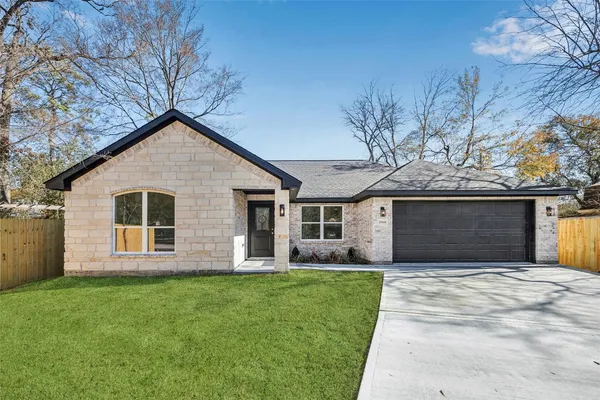 a front view of house with yard and green space