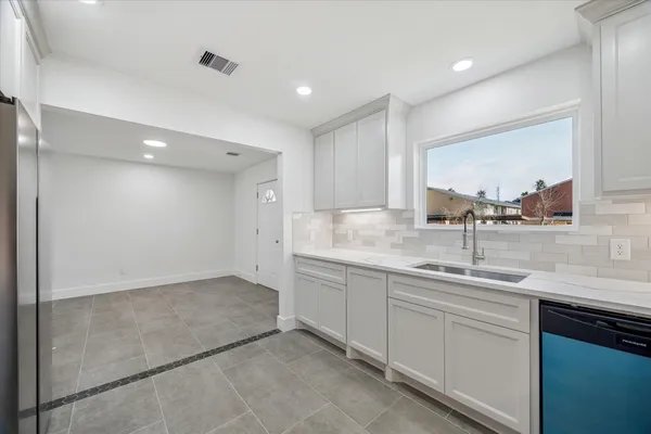 a kitchen with a sink and cabinets
