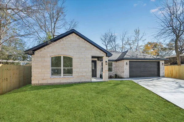 a view of a house with a yard and pathway