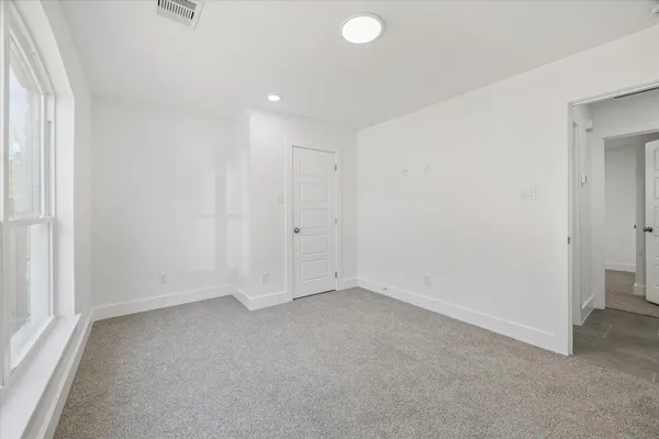 an empty room with a empty space and a window