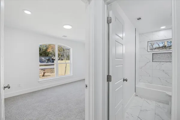 a view of an empty room with a window