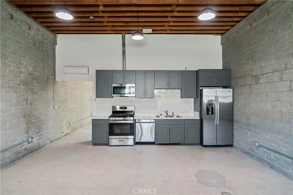 a kitchen with stainless steel appliances granite countertop a stove and a refrigerator