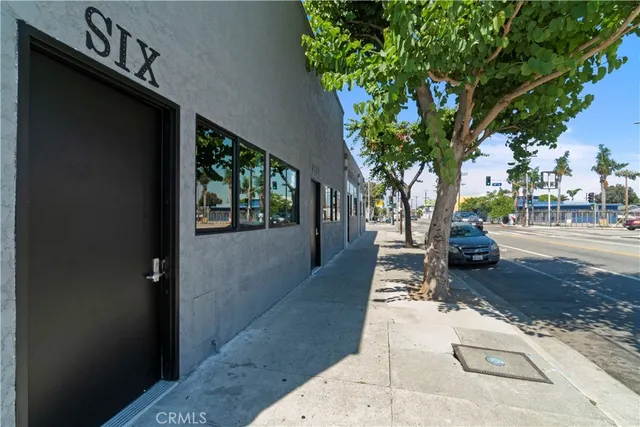 a living room with furniture kitchen view and a chandelier