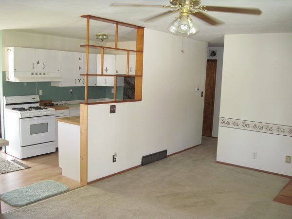 354 Cleveland Avenue Rochelle, IL 61068 - Photo 4 of 22 a kitchen with a refrigerator a stove top oven a sink and cabinets