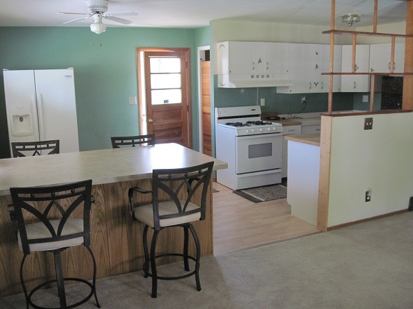 354 Cleveland Avenue Rochelle, IL 61068 - Photo 6 of 22 a kitchen with stainless steel appliances kitchen island granite countertop a table chairs and a refrigerator
