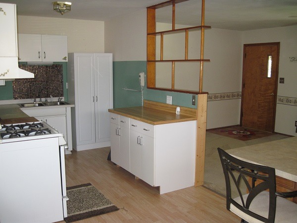 354 Cleveland Avenue Rochelle, IL 61068 - Photo 10 of 22 a kitchen with a stove a refrigerator and a stove top oven